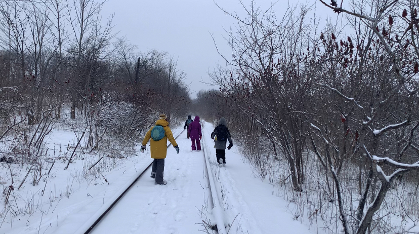 Kids walking along old rail path outdoors in the snow