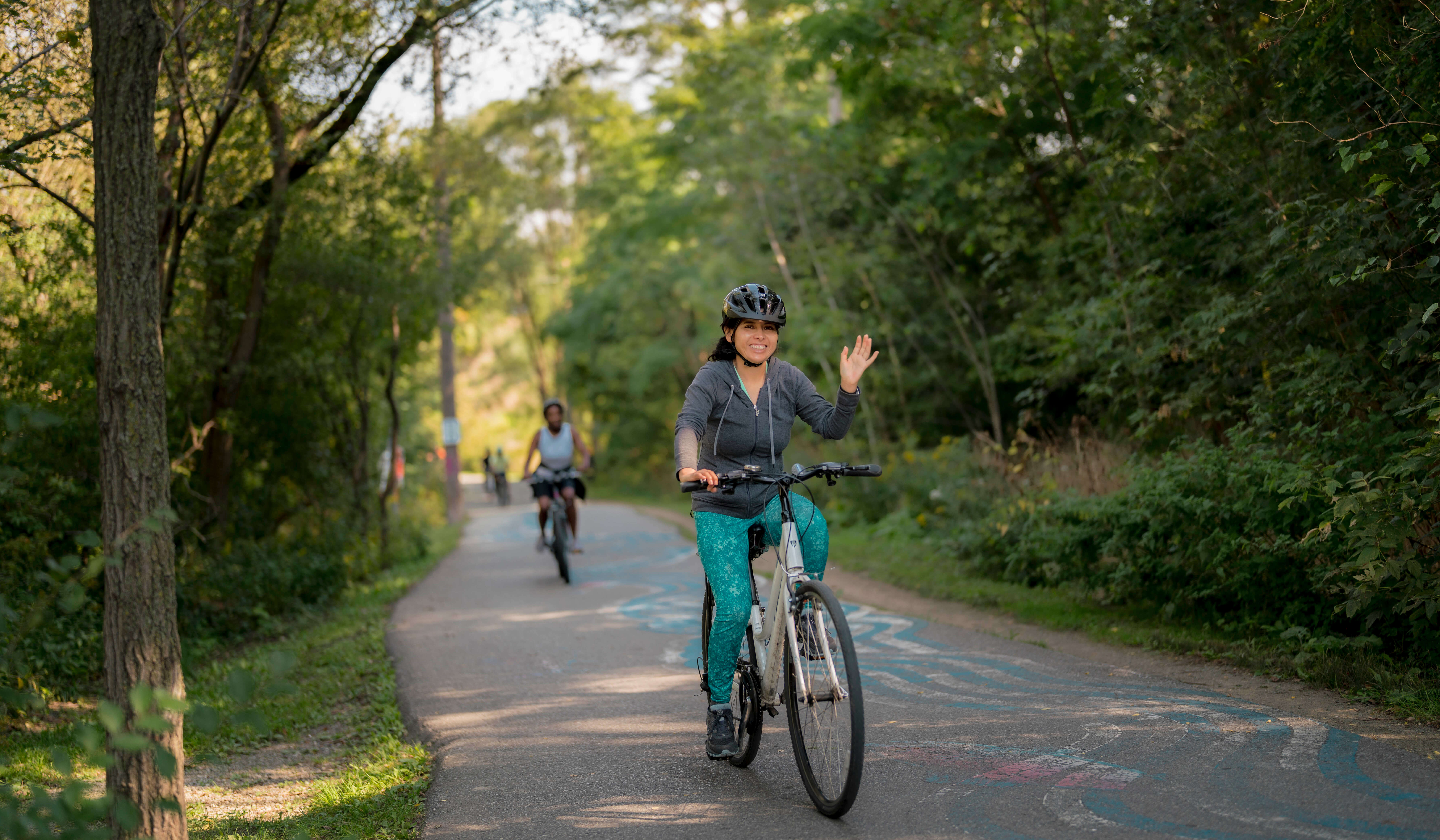 Cyclists ride by on ravine path