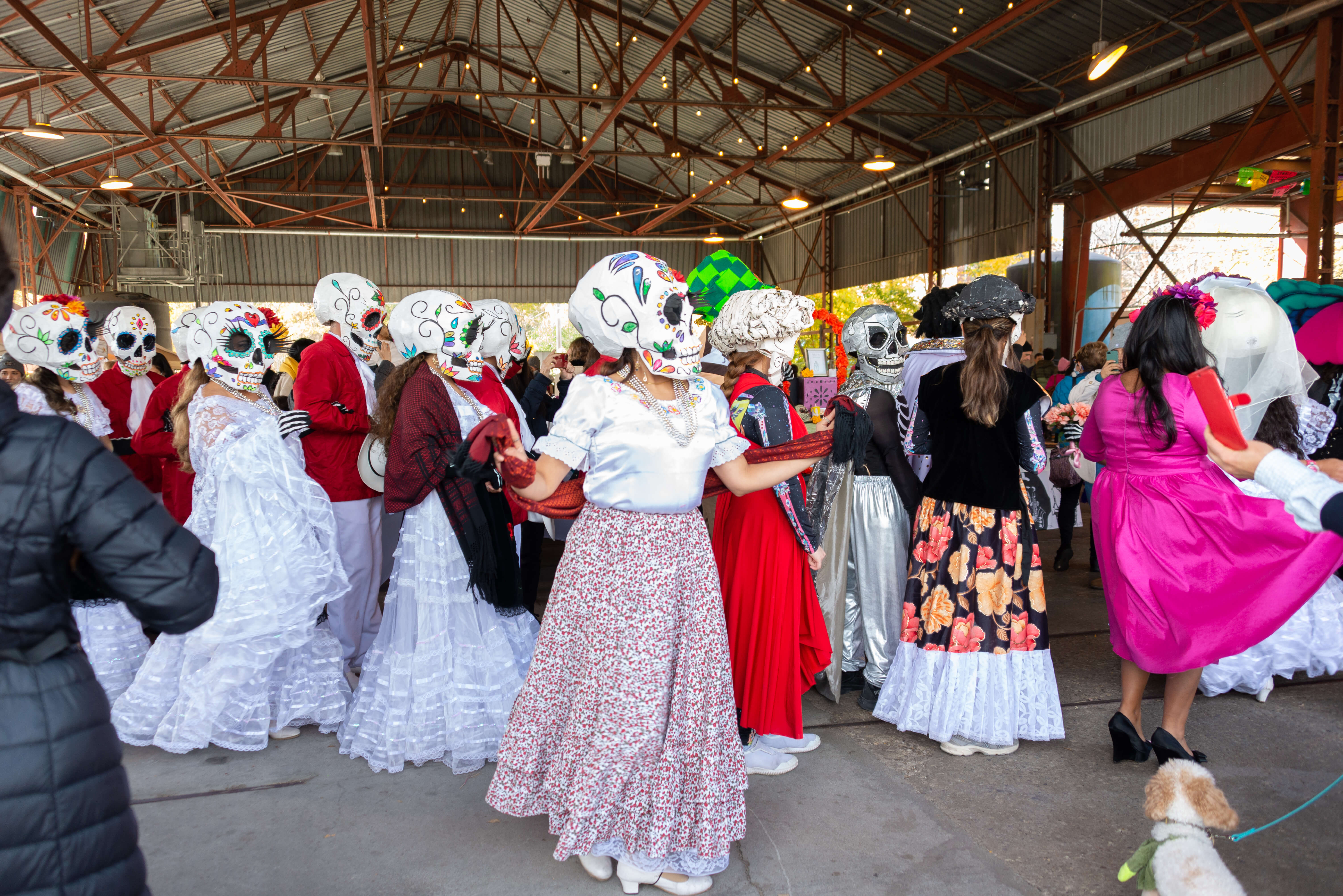 People dance in costumes at the Day of the Dead celebrations at Evergreen Brick Works