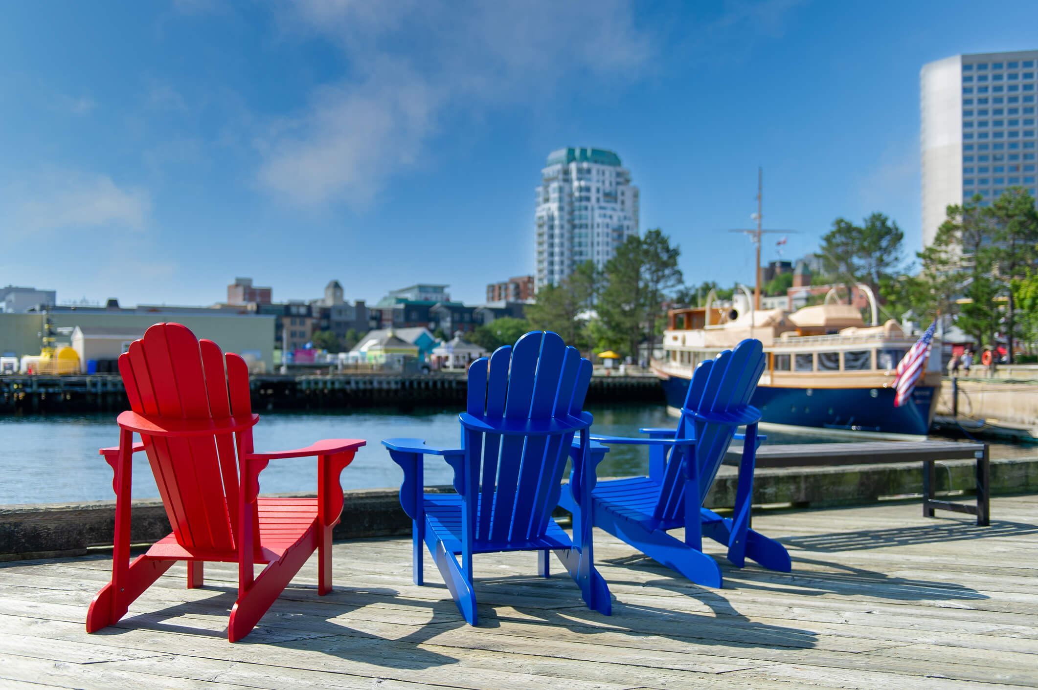 Chairs on waterfront with city in the background